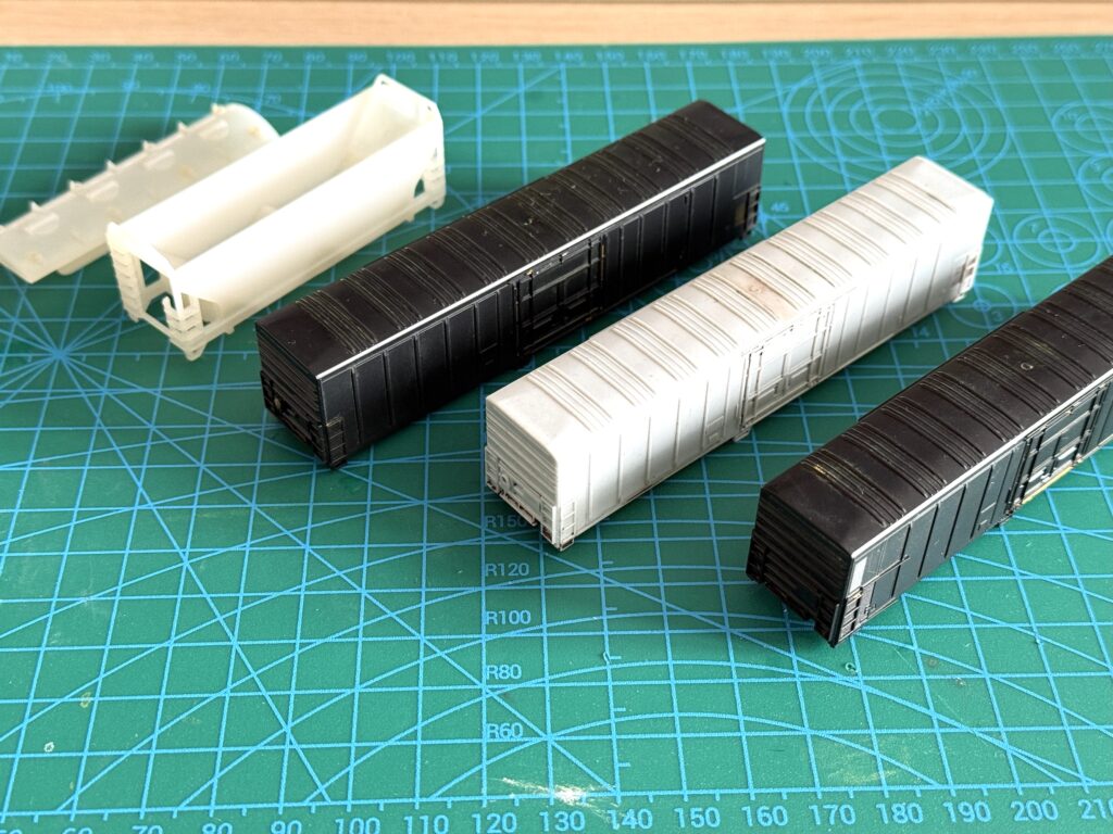 Car shells ready to be primed with Vallejo White Primer