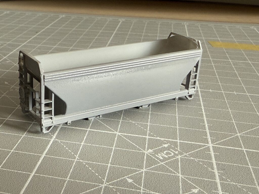 ACF 2-bay covered hopper painted a basic gray.