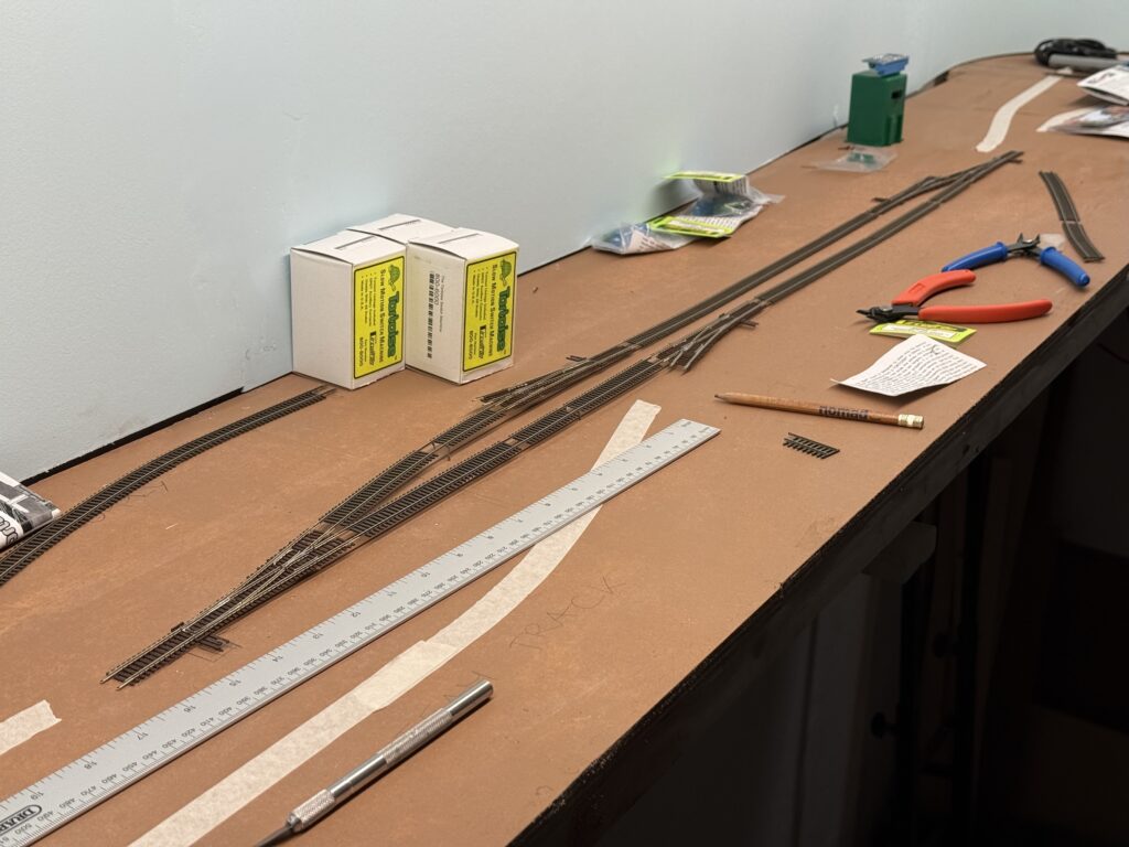 Wiring and Laying Tracks: Test-fitting the Atlas code 55 turnouts and Micro-Engineering code 55 flextrack.