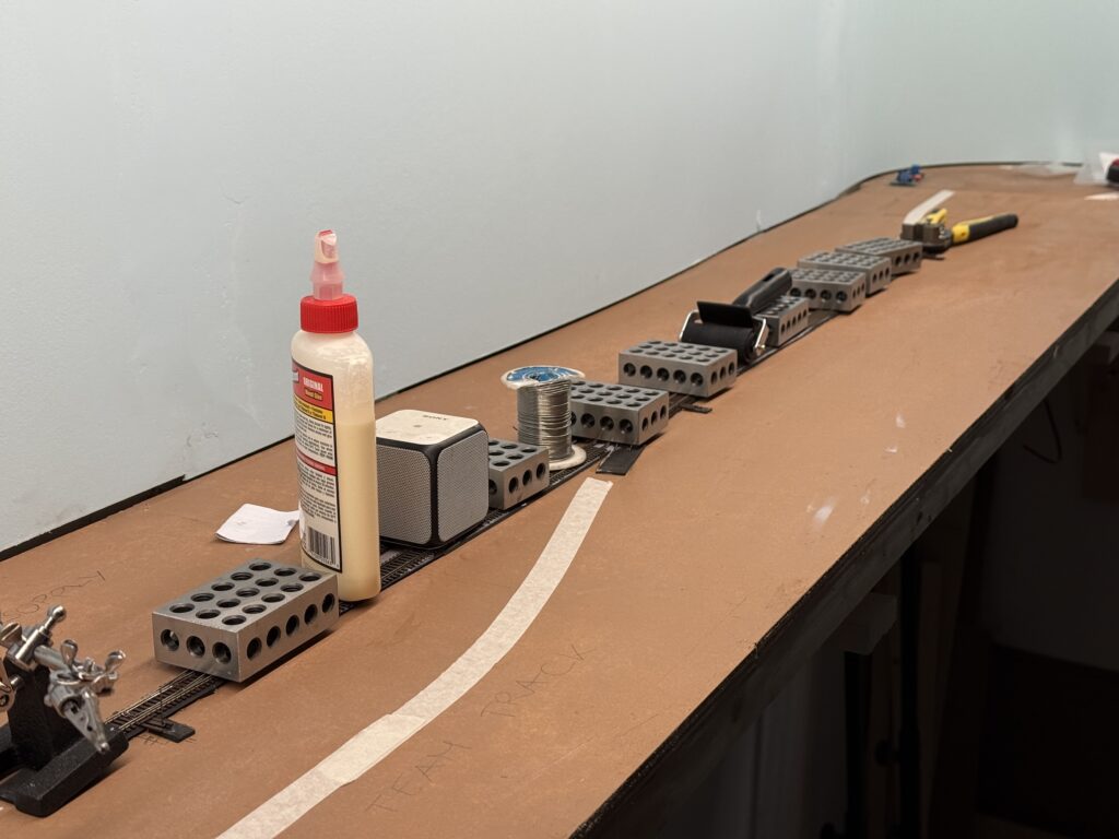 Glueing track with acrylic caulk