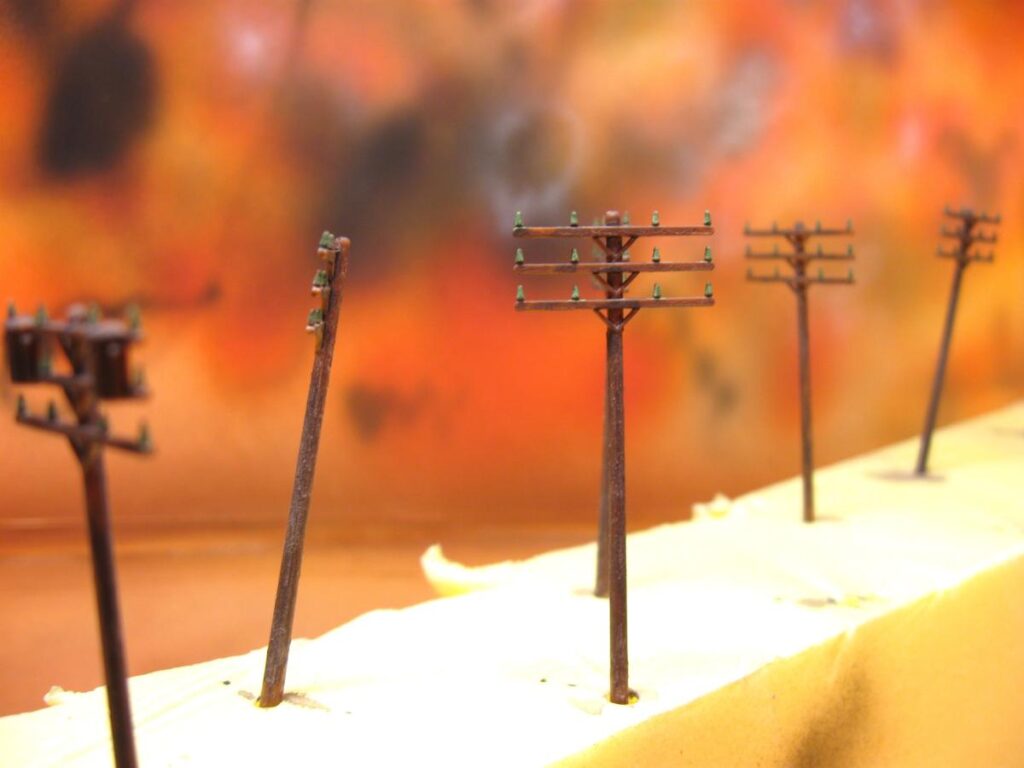 Telephone poles, painted and weathered