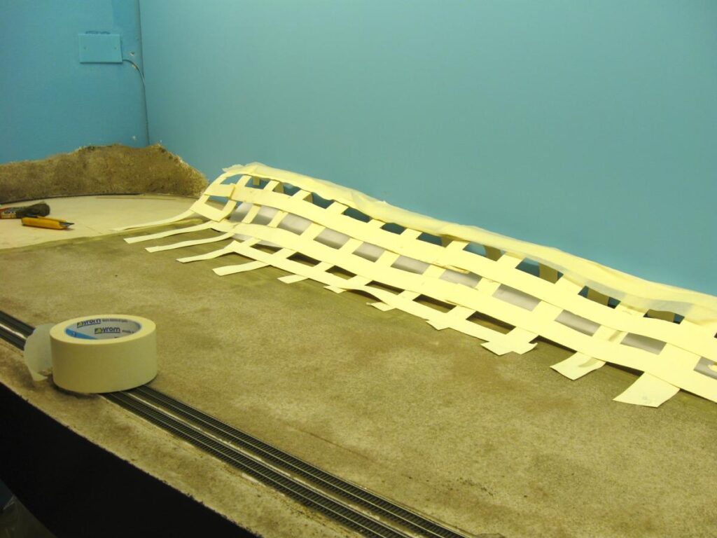 Cardboard strips and masking tape technique to shape hills.