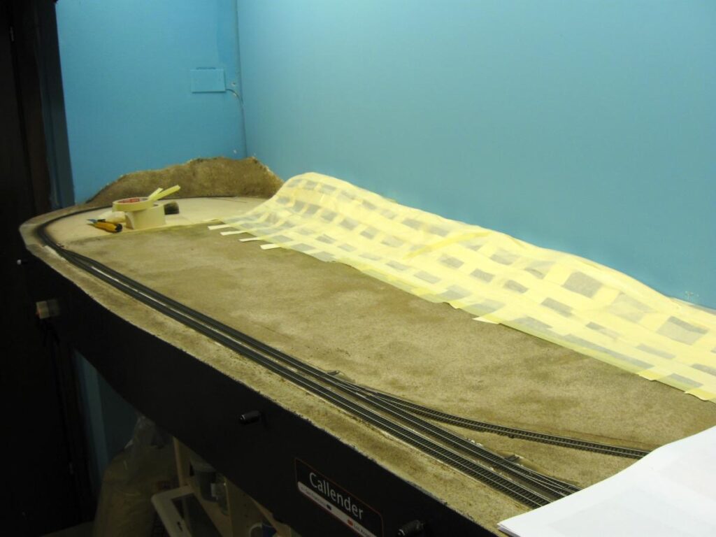 Cardboard strips and masking tape technique to shape hills.