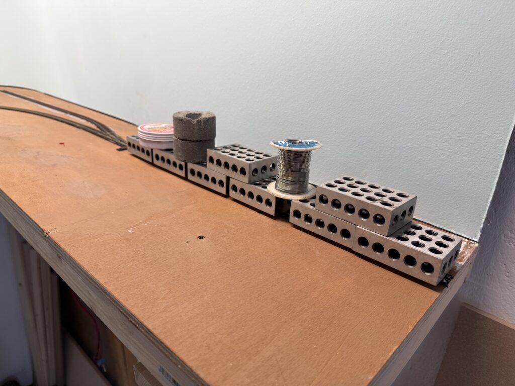 Using metal weights to keep the track firmly down, while glue dries.