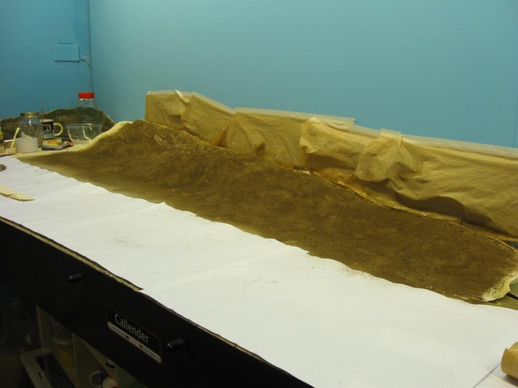 Cardboard strips and masking tape covered with plaster of Paris