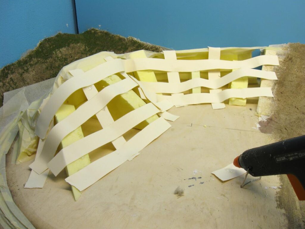 Cardboard strips and masking tape technique to shape hills.