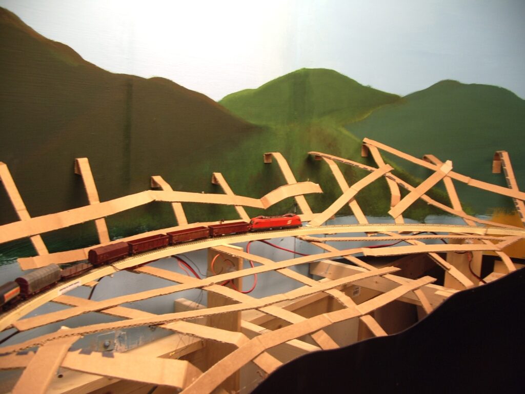Terrain construction: cardboard strips held together with hot glue.