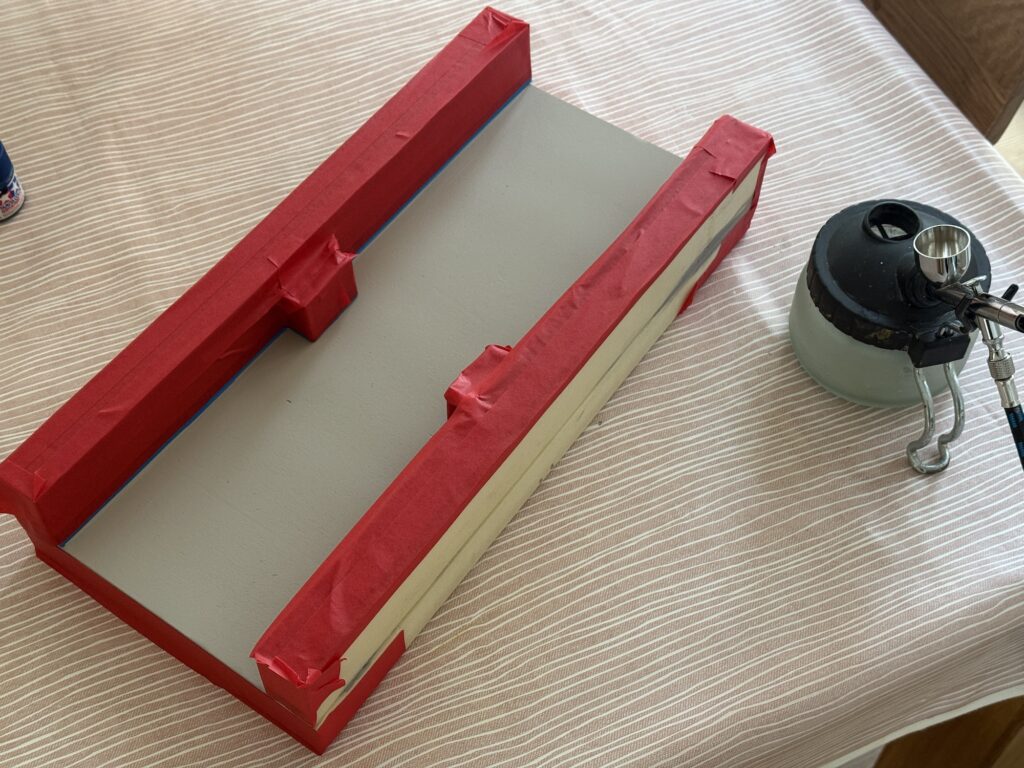 Installing a bridge: Painting the foam riverbed and river banks gray