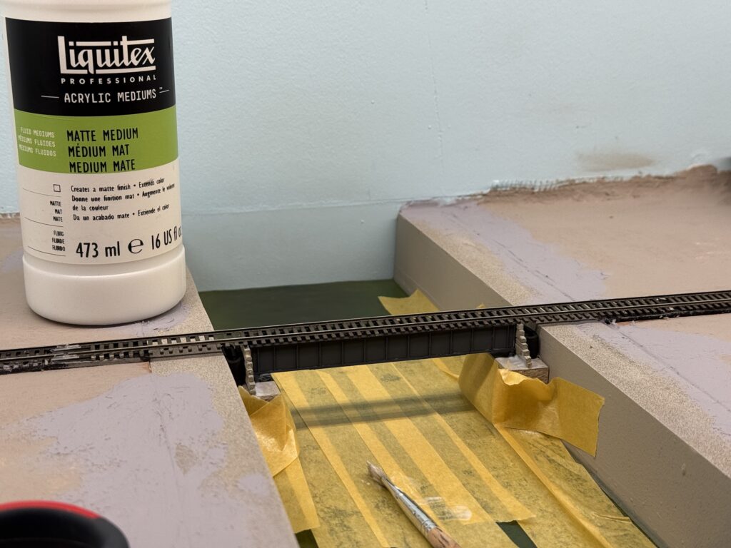 Glueing the bridge down with Liquitex Matte Medium