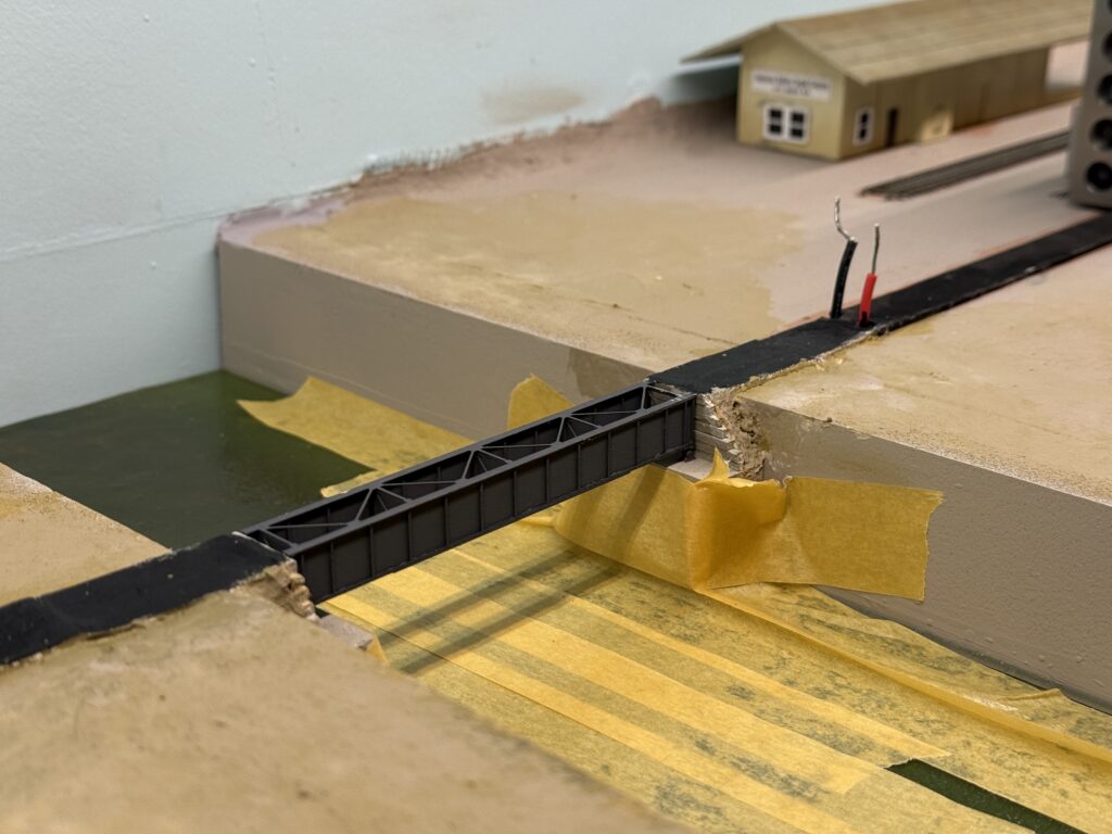 Papier-mâché terrain behind the retaining wall