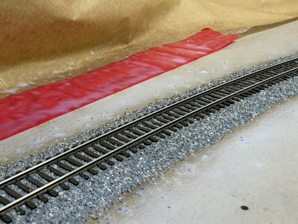Track ballast misted with water and alcohol