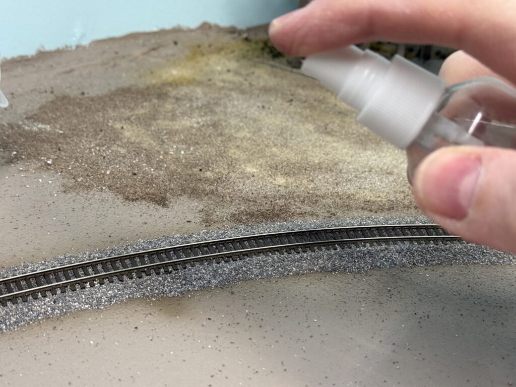 Misting the weathering powder with water